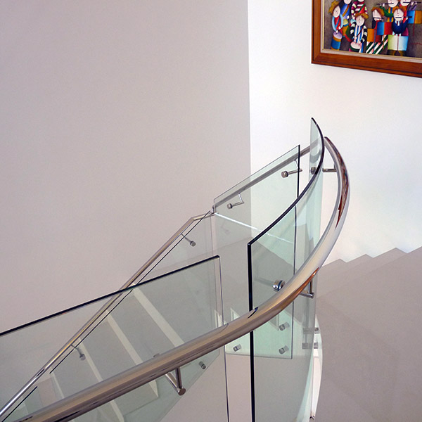 Curved glass balustrade with stainless steel posts for a premium Brisbane property exterior